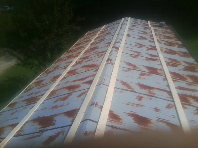 Rusted metal roof panels with new wood purlins before replacement — Storm Damage Roof Repair in Mount Joy by Roofing Brothers