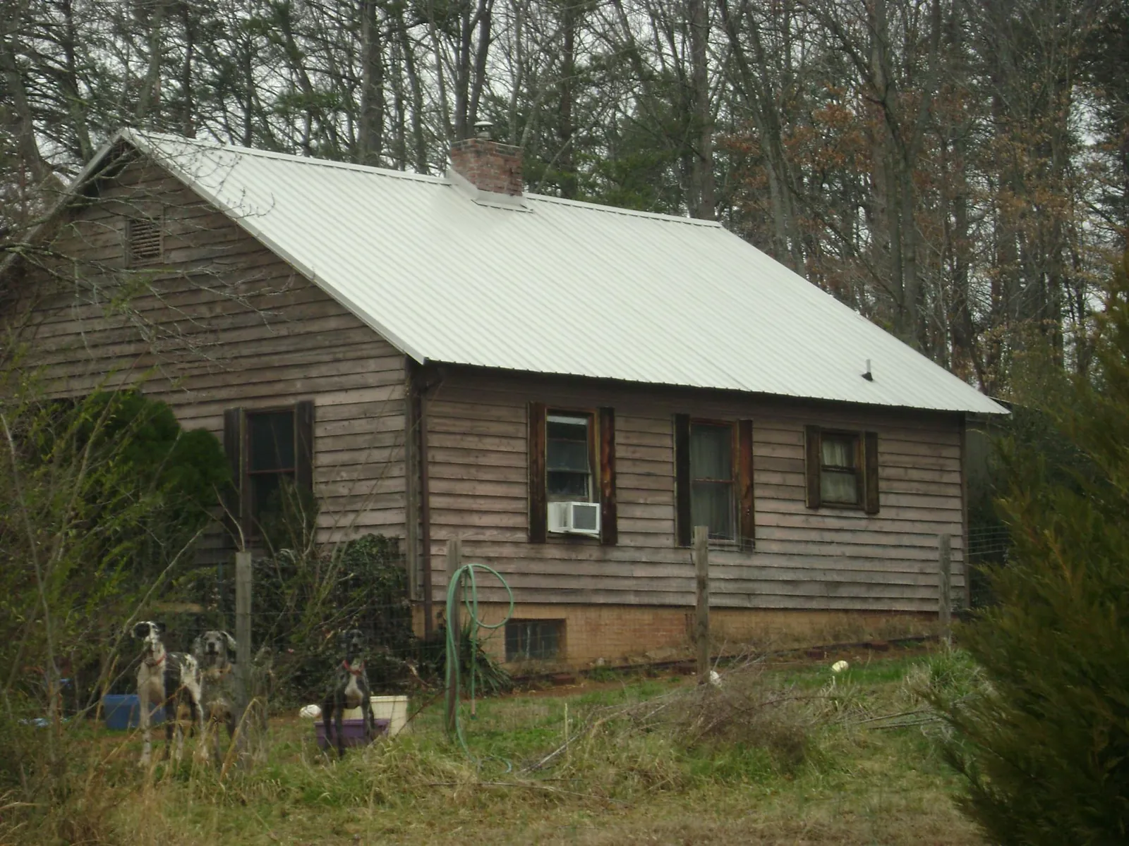White metal roof on an old wood sided farmhouse, from a Metal Roof Installation job in Mount Joy